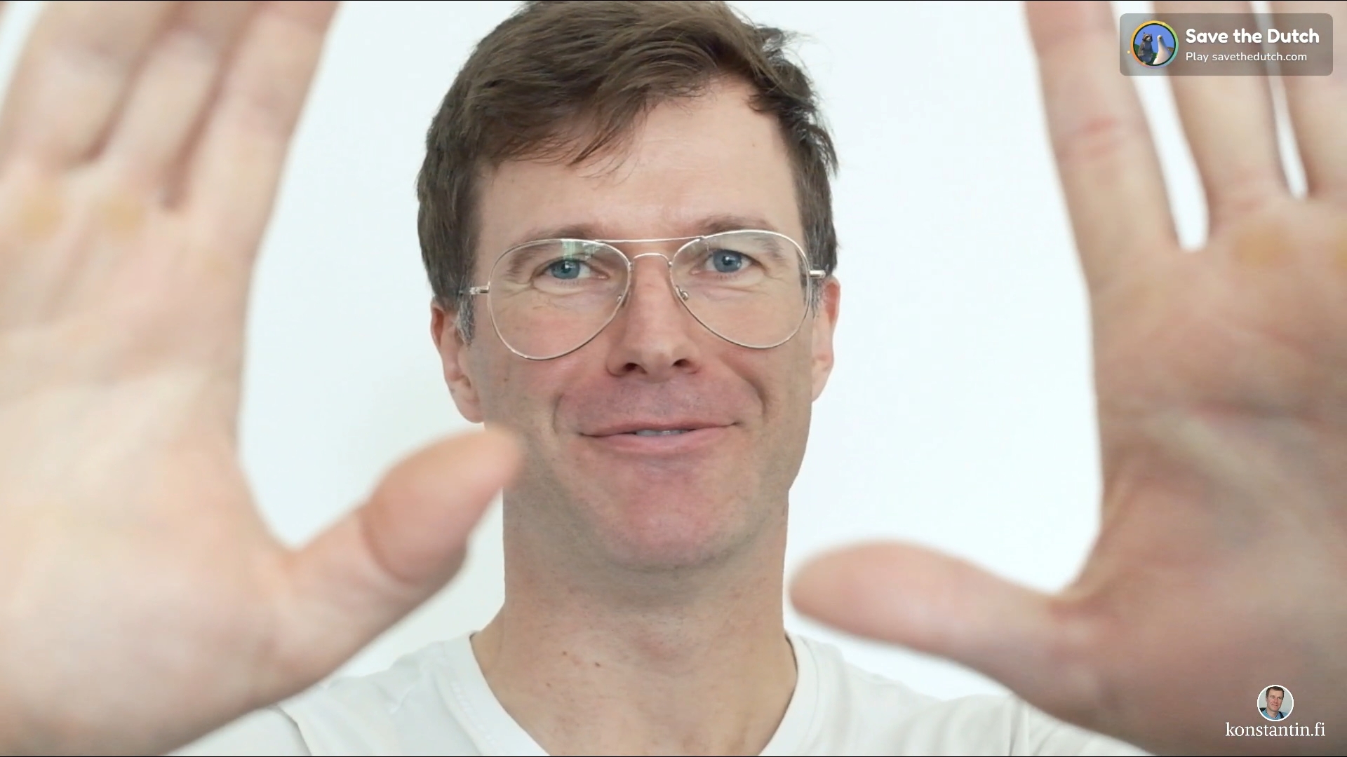 Konstantin Nikkari smiling at the camera, framing it with both hands